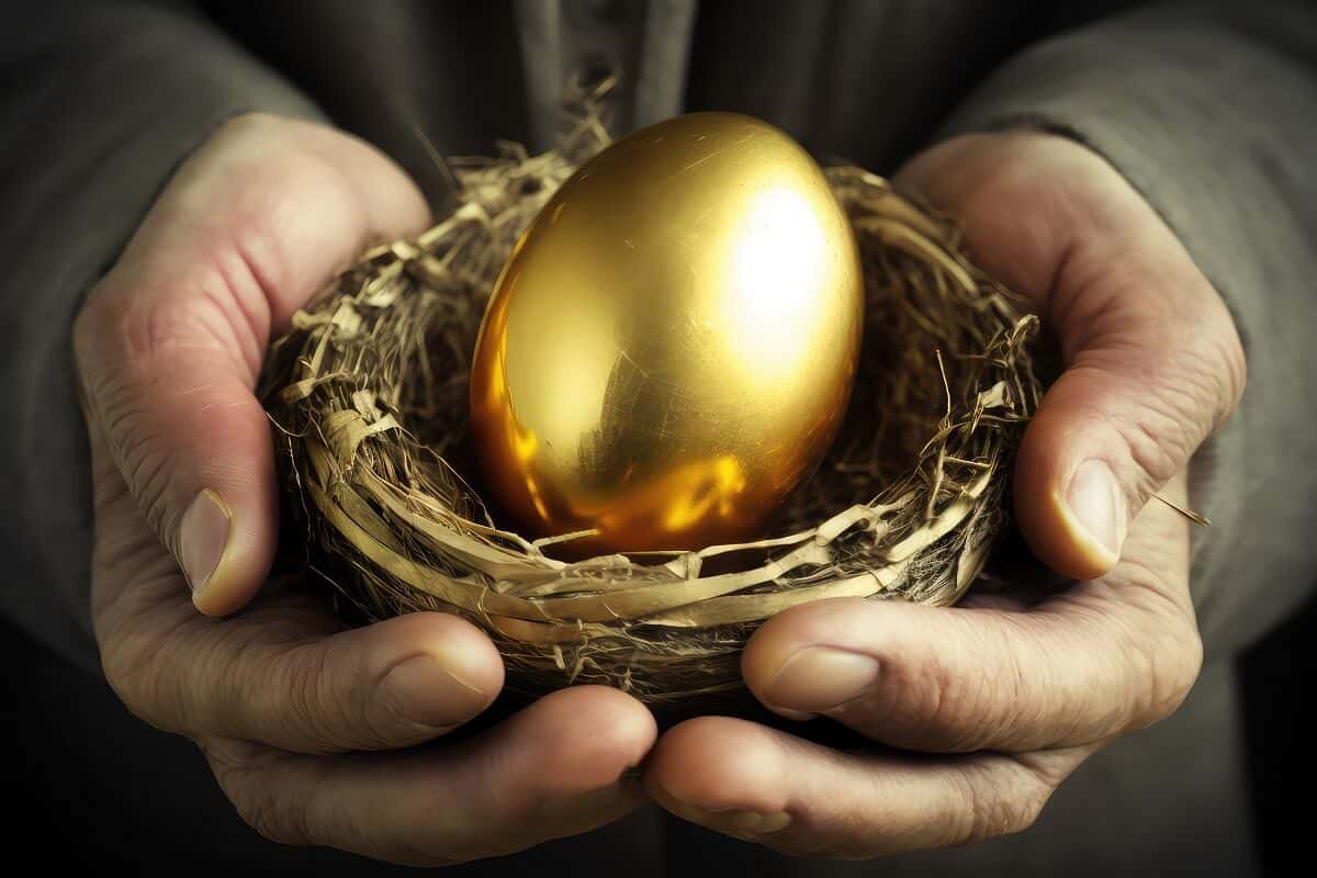 Hands Of Old Man Holding Golden Nest Egg